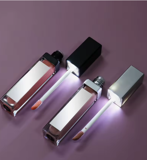 Two lip gloss tubes with illuminated wand applicators